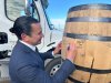 Manitoba Premier Wab Kinew signs barrels outside the Diageo plant where Crown Royal whisky is produced, in Gimli, Man., on Tuesday, Jan. 13, 2026. Kinew is calling on Ontario Premier Doug Ford to cancel a planned boycott of the whisky. THE CANADIAN PRESS/Steve Lambert