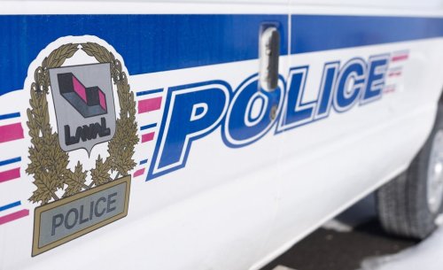 Signage is seen on a police car in Laval, Que., on Friday, Feb. 7, 2025. THE CANADIAN PRESS/Christinne Muschi