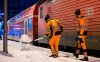 Workers clear snow from a platform at the main station after heavy snowfall, in Hamburg, Germany, Saturday, Jan. 10, 2026. ( Daniel Bockwoldt/dpa via AP)