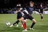 FILE - Washington's Connor Lofy (26) and North Carolina State's Donavan Phillip, left, fight for the ball during the first half of the NCAA College Cup National Championship soccer final in Cary, N.C., Dec. 15, 2025. (AP Photo/Ben McKeown, File)