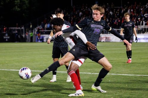 FILE - Washington's Connor Lofy (26) and North Carolina State's Donavan Phillip, left, fight for the ball during the first half of the NCAA College Cup National Championship soccer final in Cary, N.C., Dec. 15, 2025. (AP Photo/Ben McKeown, File)