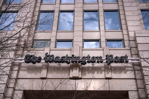 A sign for the Washington Post is seen at the company's offices, Monday, Jan. 26, 2026, in Washington. (AP Photo/Mark Schiefelbein)