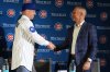 New Chicago Cubs infielder Alex Bregman, left, shakes hands with Chicago Cubs president of baseball operations Jed Hoyer at a news conference in Chicago, on Thursday, Jan. 15, 2026. (AP Photo/Nam Y. Huh)