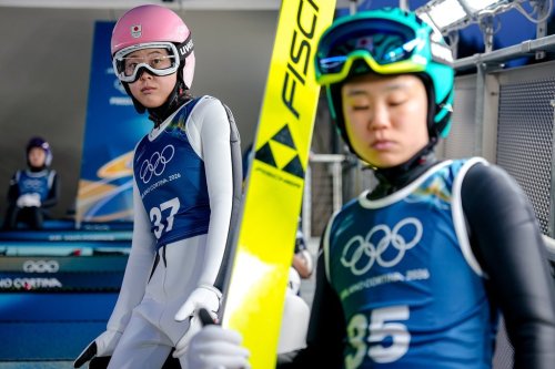 Yuka Seto, of Japan, and Yuki Ito, also of Japan, right, wait their turn to jump during a ski jumping training session, at the 2026 Winter Olympics, in Predazzo, Italy, Thursday, Feb. 5, 2026. (AP Photo/Matthias Schrader)