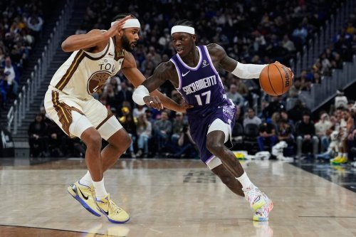 Sacramento Kings guard Dennis Schröder, right, moves the ball while defended by Golden State Warriors guard Moses Moody during the first half of an NBA basketball game, Friday, Jan. 9, 2026, in San Francisco. (AP Photo/Godofredo A. Vásquez)