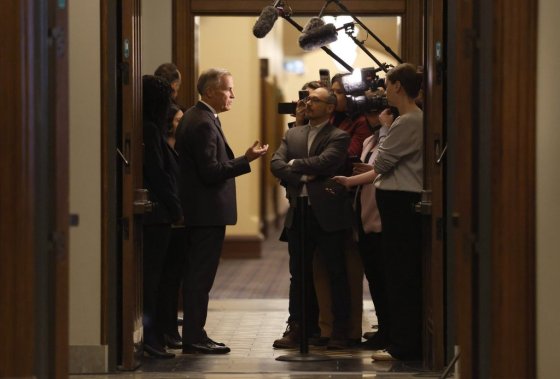 Prime Minister Mark Carney speaks to reporters as he arrives to a caucus meeting on Parliament Hill in Ottawa on Sunday. (Patrick Doyle / The Canadian Press)
