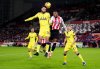 Tottenham Hotspur's Rodrigo Bentancur, left, and Brentford's Rico Henry in action during the English Premier League soccer match between Brentford and Tottenham Hotspur in London, Thursday Jan. 1, 2026. (John Walton/PA via AP)