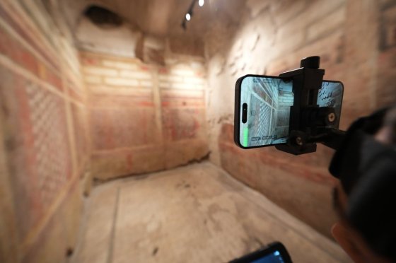 Colosseum Archeological Park guide Valentina uses a head-mounted device to livestream a guided tour of the newly-restored underground House of Griffins. (Andrew Medichini / The Associated Press)