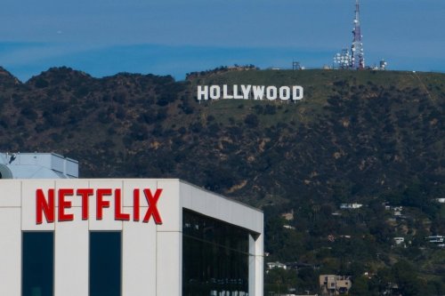 FILE - A Netflix sign is displayed atop a building in Los Angeles, on Dec. 18, 2025, with the Hollywood sign in the distance. (AP Photo/Jae C. Hong, File)