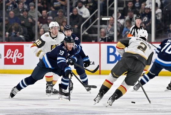 Vegas Golden Knights' Zach Whitecloud (2) passes the puck past Winnipeg Jets' Jonathan Toews (19) during their Jan. 6 game. (Fred Greenslade / The Canadian Press files)