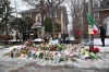 People gather around a makeshift memorial honoring the victim of a fatal shooting involving federal law enforcement agents, near the site of the shooting, Thursday, Jan. 8, 2026, in Minneapolis. (AP Photo/Tom Baker)