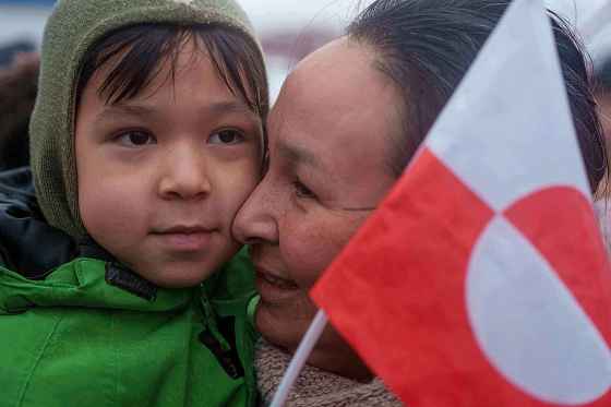 An Inuit woman holds her child during a protest against Trump's policy towards Greenland in front of the US consulate in Nuuk, Greenland, Saturday, Jan. 17, 2026. (Evgeniy Maloletka / The Associated Press files)