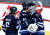 Winnipeg Jets' Mark Scheifele (55) congratulates goaltender Eric Comrie (1) for the win over the Los Angeles Kings in NHL action in Winnipeg, Friday, January 9, 2026. THE CANADIAN PRESS/John Woods