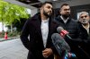 Dhanushka Wickramasinghe, centre, looks on towards Immigration Lawyer and family representative Ronalee Carey as she speaks to reporters outside of the Ottawa Courthouse in Ottawa, on Thursday, Nov. 6, 2025. Wickramasinghe is the sole survivor of a mass stabbing incident in Ottawa’s Barrhaven region that took the lives of his four children, his wife and a family friend. THE CANADIAN PRESS/Spencer Colby