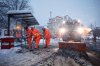 Hamburg municipal workers clear ice and snow from a bus stop at Stephansplatz, in Hamburg, Germany, Friday, Jan. 9, 2026. (Christian Charisius/dpa via AP)