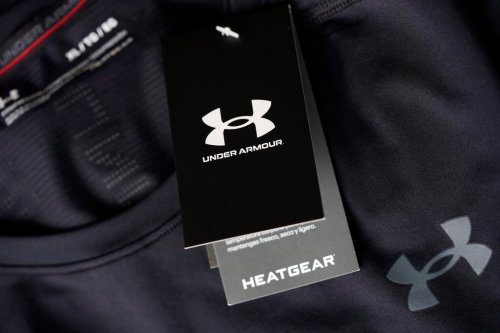 FILE - The company logo graces a sales tag on a compression shirt for sale in an Under Armour store in an outlet mall on May 3, 2021, in Lakewood, Colo. (AP Photo/David Zalubowski, File)