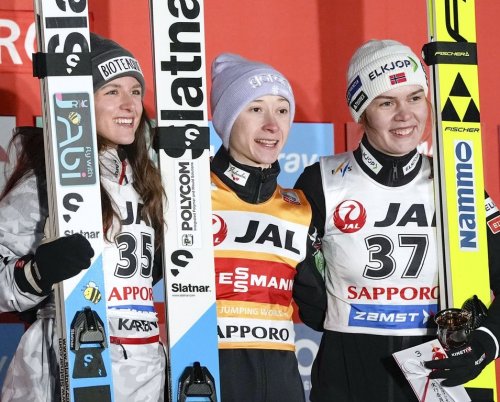 Winner Nika Prevc of Slovenia, centre, second place Abigail Strate of Canada, left, and third place Anna Odine Strom of Norway celebrate after the women's large hill individual event, during the Ski Jumping World Cup in Sapporo, northern Japan, Saturday Jan. 24, 2026. (Yuta Omori/Kyodo News via AP)