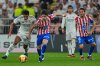 Atletico Madrid's Conor Gallagher, second left, duels for the ball with Real Madrid's Jude Bellingham during the Spanish Super Cup semifinal soccer match at King Abdullah Sports City Stadium in Jeddah, Saudi Arabia, Thursday, Jan. 8, 2026. (AP Photo/Altaf Qadri)
