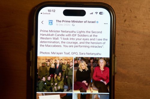 A Facebook post of the Prime Minister of Israel with a retouched photo of the Prime Minister’s wife, Sara Netanyahu, is displayed on a phone in Ramat Gan, Israel, Jan, 9, 2026 (AP Photo/Oded Balilty)