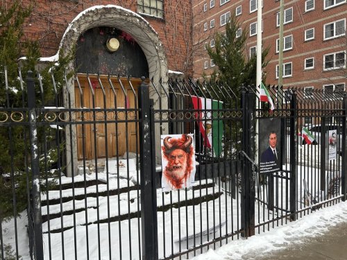 The Iranian Embassy in Ottawa, closed since 2012, on Tuesday, Jan. 13, 2026. Iran's national emblem has been removed from above the doorway and a sign and a flag used by anti-regime protesters can be seen attached to the fence. THE CANADIAN PRESS/Dylan Robertson