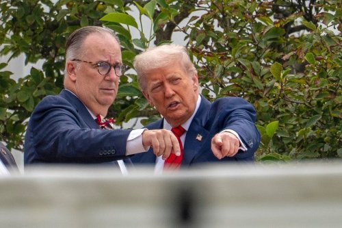 FILE - President Donald Trump, with architect James McCrery, left, surveys the grounds from the roof above the Colonnade that goes to the West Wing of the White House, Aug. 5, 2025, in Washington. (AP Photo/Alex Brandon, File)