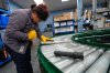 Maintenance technician Liz Cardenas replaces a conveyor belt roller at a training area in a Walmart distribution center Thursday, Sept. 25, 2025, in Bentonville, Ark. (AP Photo/Charlie Riedel)
