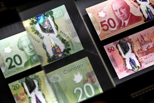 A magnifying glass enlarges the holographic image of Parliament Hill's Peace Tower on a 20 dollar bill issued by the Bank of Canada, shown in a display case at the Bank of Canada Museum in Ottawa, on Wednesday, Sept. 4, 2024. THE CANADIAN PRESS/Justin Tang