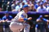 FILE - Chicago Cubs catcher Reese McGuire (20) kneels in the third inning of a baseball game Aug. 31, 2025, in Denver. (AP Photo/David Zalubowski, File)