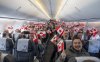 Passengers on an Air Inuit flight wave flags as they travel from Montreal to Nuuk, Greenland on Thursday, Feb. 5, 2026. THE CANADIAN PRESS/Christinne Muschi