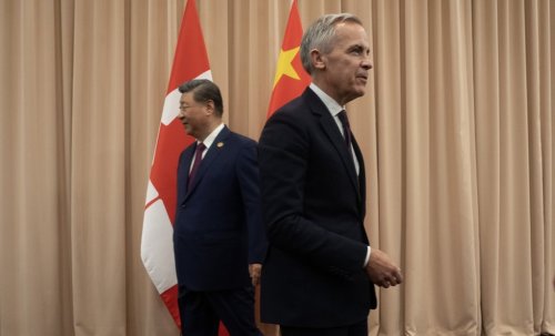 Prime Minister Mark Carney and Chinese President Xi Jinping make their way to their seats after shaking hands at the start of a meeting in Gyeongju, Friday, Oct. 31, 2025. THE CANADIAN PRESS/Adrian Wyld