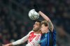 Arsenal's Mikel Merino, left, jumps for the ball with Inter Milan's Nicolo Barella during the Champions League opening phase soccer match between Inter Milan and Arsenal in Milan, Italy, Tuesday, Jan. 20, 2026. (AP Photo/Luca Bruno)
