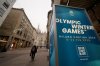 People walk through the Corso Vittorio Emanuele II main downtown street as Olympic Iconic neons hang for the upcoming Milan Cortina Winter Olympics in Milan, Italy, Friday, Jan. 9, 2026. THE CANADIAN PRESS/AP-Luca Bruno