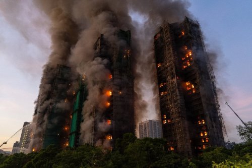 FILE - Smoke rises after a fire broke out at Wang Fuk Court, a residential estate in the Tai Po district of Hong Kong's New Territories, Nov. 26 2025. (AP Photo/Chan Long Hei, File)
