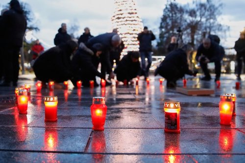 People light candles to express their compassion and solidarity to the victims of the deadly fire in a bar in Crans-Montana, Switzerland, during a vigil in Kocani, North Macedonia, on Saturday, Jan. 10, 2026. (AP Photo/Boris Grdanoski)