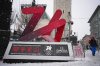 People walk past a Milano Cortina 2026 Olympic logo with a countdown screen, in Cortina d'Ampezzo, Italy, Wednesday, Feb. 4, 2026. (AP Photo/Fatima Shbair)