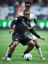 Vancouver FC's Thierno Bah, front, and Vancouver Whitecaps' Ali Ahmed (22) vie for the ball during the second half of the Canadian Championship final soccer match, in Vancouver, on Wednesday, October 1, 2025. THE CANADIAN PRESS/Ethan Cairns