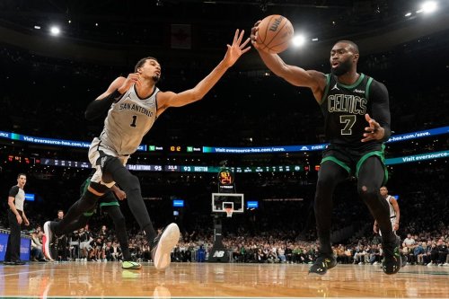 Boston Celtics guard Jaylen Brown (7) grabs a defensive rebound against San Antonio Spurs forward Victor Wembanyama (1) during the second half of an NBA basketball game, Saturday, Jan. 10, 2026, in Boston. (AP Photo/Robert F. Bukaty)