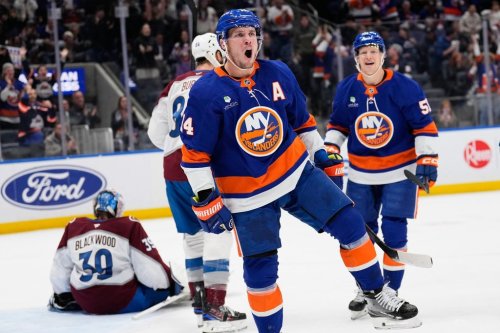 FILE - New York Islanders' Bo Horvat (14) reacts after scoring during the second period of an NHL hockey game against the Colorado Avalanche, Dec. 4, 2025, in Elmont, N.Y. (AP Photo/Seth Wenig, File)