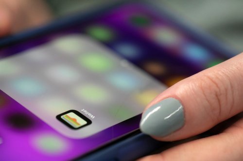 FILE - A person uses an iPhone on Oct. 8, 2019 in New York. ne models and later some Mac computers to get access to genuine Apple parts and tools to be able to repair them. (AP Photo/Jenny Kane, File)