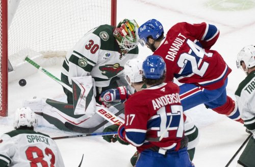 Montreal Canadiens' Phillip Danault (24) scores on Minnesota Wild goaltender Jesper Wallstedt (30) during first period NHL hockey action in Montreal on Tuesday, Jan. 20, 2026. THE CANADIAN PRESS/Christinne Muschi