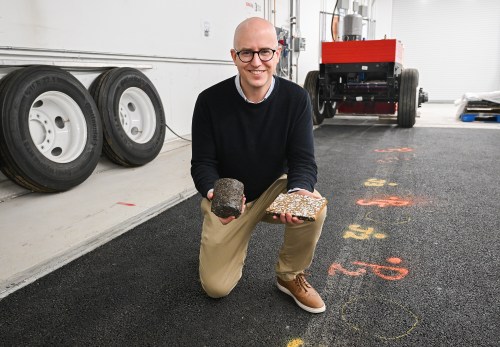 Alan Carter, a professor at Ecole de technologie superieure (ETS), poses with lab-produced asphalt samples on an accelerated loading facility at his laboratory at the school in Montreal, Thursday, Jan. 29, 2026. THE CANADIAN PRESS/Graham Hughes