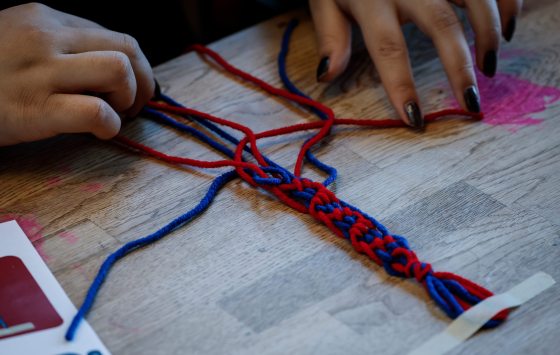 A person practices her sash-weaving skills as people take in Riel Day events at the Forks Feb. 16. (John Woods / Free Press)