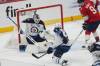Winnipeg Jets goaltender Eric Comrie (1) stops a shot on goal during the first period of an NHL hockey game against the Florida Panthers, Saturday, Jan. 31, 2026, in Sunrise, Fla. (AP Photo/Marta Lavandier)