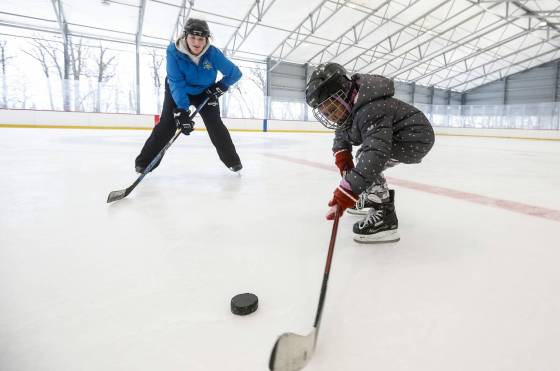 Sam Taylor, activity leader, helps a young person learn to skate at Camp Manitou in Headingley on Sunday. (John Woods / Free Press)
