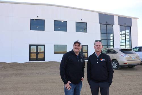 AgWest Brandon branch manager Derek Papineau (right) stands in front of the new facility with his assistant, Mike Noto. (Abiola Odutola / The Brandon Sun files)