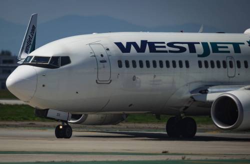 Pilots taxi a WestJet Boeing 737-700 aircraft to the runway for departure from Vancouver International Airport, in Richmond, B.C., on Friday, May 19, 2023. The WestJet Group averted a strike after reaching a last-minute deal with the airline&rsquo;s pilots early Friday, but not before cancelling hundreds of flights and upending the long weekend plans of thousands of passengers. THE CANADIAN PRESS/Darryl Dyck