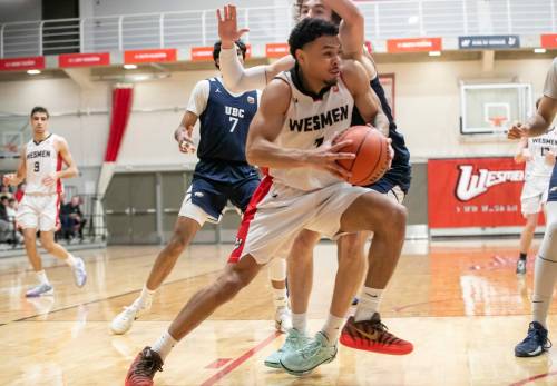 BROOK JONES/FREE PRESS
                                Wesmen guard Malachi Alexander (No. 7) drives to the hoop while Thunderbirds guard Edouard Gauthier (No. 11) covers him during second quarter action Saturday.