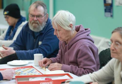 RUTH BONNEVILLE / FREE PRESS
                                Seniors play games during their time together at the weekly gathering.