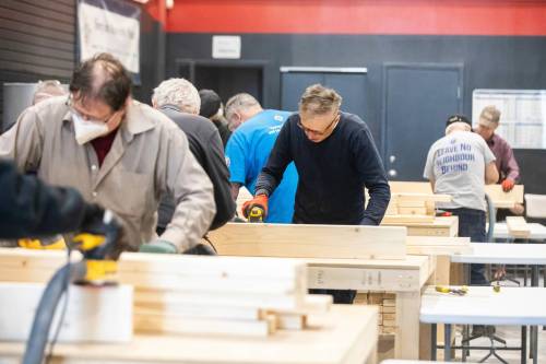 MIKAELA MACKENZIE / FREE PRESS
                                James Stewart (centre) sands pieces for one of 22 beds. The beds, along with 500 donated coats and seven wheelchairs, are headed to the remote First Nation.