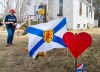 People pay their respects at a roadside memorial in Portapique, N.S., on Sunday, April 26, 2020, after a lone gunman killed 22 people in rural Nova Scotia. THE CANADIAN PRESS/Andrew Vaughan